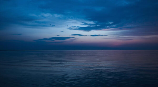 dimly lit blue sky with water