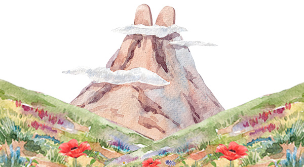 Mountain surrounded by floating clouds and a colorful foreground with flowers